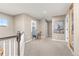 Upstairs hallway featuring neutral walls, carpeted flooring, and a charming writing desk at 6690 S Fenton St, Littleton, CO 80123