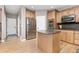 Well-equipped kitchen with stainless steel appliances, hardwood floors, granite countertops, and center island at 6690 S Fenton St, Littleton, CO 80123