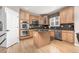Stylish kitchen with stainless steel appliances, hardwood floors, an island and granite countertops at 6690 S Fenton St, Littleton, CO 80123