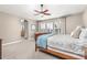 Spacious main bedroom with natural light, ceiling fan, and a glimpse into the bathroom at 6690 S Fenton St, Littleton, CO 80123