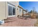 Brick patio featuring outdoor seating and steps leading to the home's sliding glass door at 6690 S Fenton St, Littleton, CO 80123