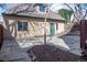 Stone-paved backyard, adjacent to the back of the house, with a small tree in the center at 433 N Ogden St, Denver, CO 80218