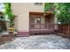 An inviting backyard featuring a wooden deck, stone patio, and mature trees at 433 N Ogden St, Denver, CO 80218
