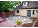 Quaint backyard featuring stone patio, mature trees, and access to the home at 433 N Ogden St, Denver, CO 80218