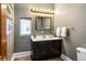 Cozy half-bath with a decorative mirror, a dark vanity, and decorative lighting at 433 N Ogden St, Denver, CO 80218