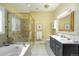Elegant bathroom featuring a soaking tub, glass enclosed shower, and a double sink vanity at 433 N Ogden St, Denver, CO 80218