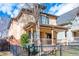 Charming two-story home featuring a covered porch with decorative columns and a well-maintained front yard at 433 N Ogden St, Denver, CO 80218
