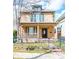 Charming two-story home with a welcoming front porch and decorative shutters at 433 N Ogden St, Denver, CO 80218