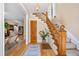 Elegant foyer with hardwood floors, a wooden staircase, and a view into the spacious living room at 433 N Ogden St, Denver, CO 80218