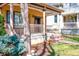 Inviting covered porch with classic columns, decorative flowerpots, and a well-manicured lawn at 433 N Ogden St, Denver, CO 80218