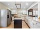 Open kitchen featuring stainless steel appliances, white cabinets, an island, and granite countertops at 433 N Ogden St, Denver, CO 80218