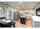 Well-lit kitchen featuring stainless steel appliances, an island, and a door leading to the outside at 433 N Ogden St, Denver, CO 80218