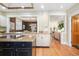 Eat-in kitchen featuring stainless steel appliances, an island, granite countertops, and hardwood floors at 433 N Ogden St, Denver, CO 80218