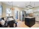 Bright eat-in kitchen featuring stainless steel appliances, white cabinets, and hardwood flooring at 433 N Ogden St, Denver, CO 80218