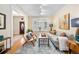 Bright living room features hardwood floors, large bay window, comfortable seating, and stylish decor at 433 N Ogden St, Denver, CO 80218