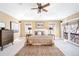 Bright main bedroom featuring a ceiling fan, hardwood floors, a large bed, and lots of natural light at 433 N Ogden St, Denver, CO 80218
