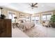 Neutral main bedroom featuring a ceiling fan, hardwood floors, a large bed, and lots of natural light at 433 N Ogden St, Denver, CO 80218