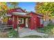 Front view of red house with porch and landscaping at 704 E Baseline Rd, Lafayette, CO 80026