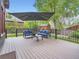 Inviting back deck with comfortable seating and an umbrella, surrounded by a well-maintained yard at 845 Urban St, Lakewood, CO 80401