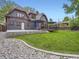 Backyard view of a home with a well-manicured lawn, patio, and inviting outdoor living area at 845 Urban St, Lakewood, CO 80401