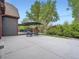 Backyard with a spacious patio, deck with lounge furniture, and lush greenery, creating a relaxing outdoor space at 845 Urban St, Lakewood, CO 80401