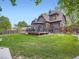 Lush backyard with a deck, patio, and green lawn, offering a perfect blend of relaxation and entertainment space at 845 Urban St, Lakewood, CO 80401