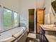 Well-lit bathroom with a soaking tub, glass-enclosed shower, and modern vanity at 845 Urban St, Lakewood, CO 80401