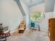 Bedroom featuring a rocking chair, desk with turquoise chair, and blue walls at 845 Urban St, Lakewood, CO 80401