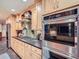 Gourmet kitchen featuring stainless steel appliances, custom cabinets, and stylish backsplash at 845 Urban St, Lakewood, CO 80401