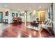Open-concept living room with hardwood floors, piano, and staircase at 845 Urban St, Lakewood, CO 80401