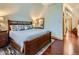 Spacious main bedroom with a large bed, hardwood floors, and ample natural light at 845 Urban St, Lakewood, CO 80401