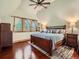 Main bedroom with hardwood floors, a large bed, and multiple windows for natural light at 845 Urban St, Lakewood, CO 80401
