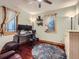 Cozy office with hardwood floors, dual monitors, decor shelving, and natural light from windows at 845 Urban St, Lakewood, CO 80401