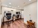 A spacious home office with wood floors, desk, multiple monitors, and ample workspace at 845 Urban St, Lakewood, CO 80401