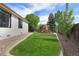 Spacious backyard with green lawn and a playset, bordered with gravel at 12513 Alcott St, Broomfield, CO 80020