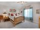 Cozy bedroom features a wood-framed bed, soft lighting, and cheerful window curtains at 12513 Alcott St, Broomfield, CO 80020
