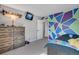 Bright, colorful bedroom featuring a tv, gray carpet and geometric accent wall at 12513 Alcott St, Broomfield, CO 80020