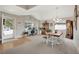 Open dining area with vaulted ceiling features natural light, wood accents, and adjacent front entry and office at 12513 Alcott St, Broomfield, CO 80020