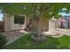 Inviting home exterior with mature tree, lush lawn, and beautiful landscaping around the walkway at 12513 Alcott St, Broomfield, CO 80020