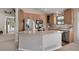 Functional kitchen with a central island, stainless steel appliances, and light wood cabinets at 12513 Alcott St, Broomfield, CO 80020