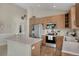 Well-lit kitchen with stainless steel appliances, light wood cabinetry, and functional layout at 12513 Alcott St, Broomfield, CO 80020
