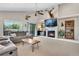 Comfortable living room featuring a fireplace, mounted TV, and sliding door access to the outdoors at 12513 Alcott St, Broomfield, CO 80020