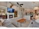 Bright living room with fireplace, high ceilings, and open layout, flowing into the kitchen at 12513 Alcott St, Broomfield, CO 80020