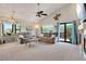 Spacious living room with large windows, vaulted ceiling and sliding glass doors to the backyard at 12513 Alcott St, Broomfield, CO 80020