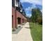 Exterior view of brick townhomes with well-maintained lawns and landscaping on a sunny day at 2144 Applewood Dr, Lakewood, CO 80215