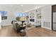 Bright living room features hardwood floors, a modern fireplace, and large windows offering ample natural light at 2144 Applewood Dr, Lakewood, CO 80215