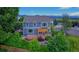 A well-manicured backyard featuring an entertainment deck, pergola, lush lawn, and surrounding landscaping at 14620 Prairie Sky Ln, Broomfield, CO 80023