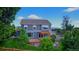 A well-manicured backyard with a deck, pergola, lush lawn, mature trees and surrounding landscaping at 14620 Prairie Sky Ln, Broomfield, CO 80023
