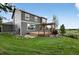 Two-story home with a spacious backyard featuring a patio with a pergola and lawn area at 14620 Prairie Sky Ln, Broomfield, CO 80023