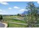 View of the walking path, stone embankments, and neighborhood from the rear of this property at 14620 Prairie Sky Ln, Broomfield, CO 80023